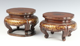 A pair of 19th Century Chinese hardwood vase stands with formal gilt scroll decoration, raised on scroll legs 17cm 