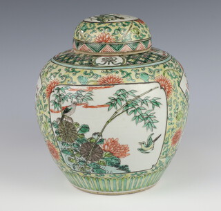 A Chinese famille vert ginger jar decorated with panels of birds amongst flowers on a ground of scrolling chrysanthemums 20cm 
