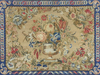 A Victorian wool work embroidery of a still life vase of flowers enclosed in a geometric border contained in a maple walnut frame 62cm x 82cm 