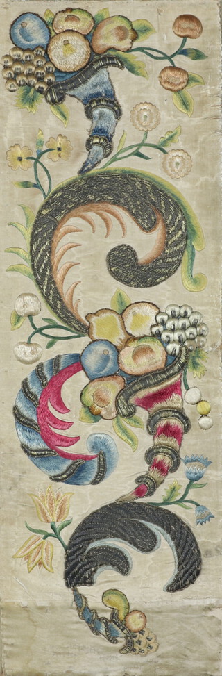 An 18th Century style Venetian silk work embroidered panel of a cornucopia, fruits and flowers 71cm x 24cm 