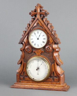 A Victorian combined timepiece and barometer, the timepiece with Roman numerals, contained in a carved and pierced oak gothic style case 41cm h x 29cm w x 7cm d 