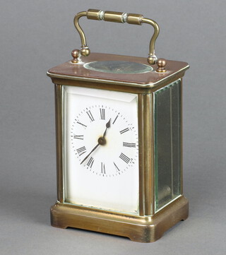 A 19th Century French carriage timepiece with enamelled dial, Roman numerals, contained in a gilt metal case, complete with key, 10cm x 7cm x 6cm 