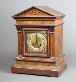 Junghans, an Edwardian Ting Tang bracket clock, having a square gilt dial with silvered chapter ring, Roman numerals, striking on 2 gongs, contained in a carved walnut architectural style case, with pendulum but no key, 44cm x 33cm x 24cm  