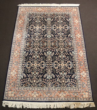 A Persian blue and pink ground floral patterned rug within a multi row border 281cm x 187cm 