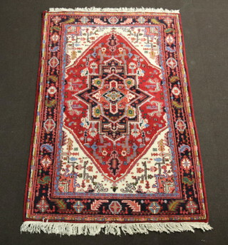 An Afghan red, white and blue ground rug with diamond medallion to the centre within a multi row border 202cm x 130cm 