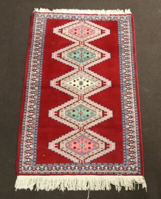 A Bokhara red, pink and turquoise ground  rug with 5 diamonds to the centre 152cm x 97cm 