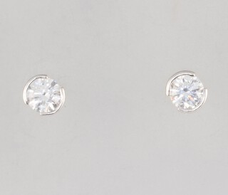 A pair of white metal stamped 750 brilliant cut diamond ear studs, approx. 0.3ct each, 1.5 grams