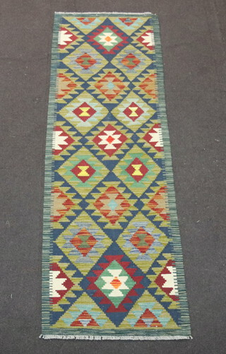 A black, brown and green ground Maimana Kilim runner with diamond design to the centre 197cm x 66cm 