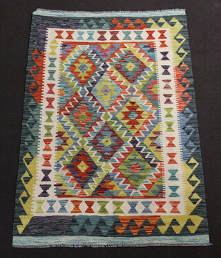 A white and green ground Chobi Kilim with diamond decoration to the centre within multi row border 150cm x 100cm 