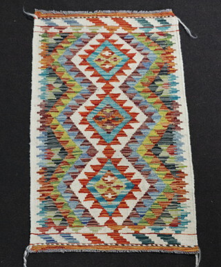A white, turquoise and orange ground Chobi Kilim rug with 3 diamonds to the centre 100cm x 60cm 