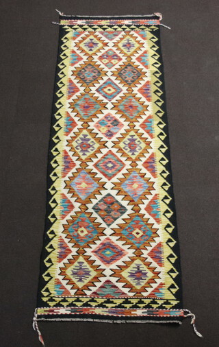 A black, white, blue and brown ground Chobi Kilim runner with all over stylised diamond design 248cm x 80cm 