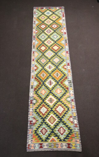 A green, brown and white ground Maimana Kilim runner with all over diamond design 400cm x 90cm 