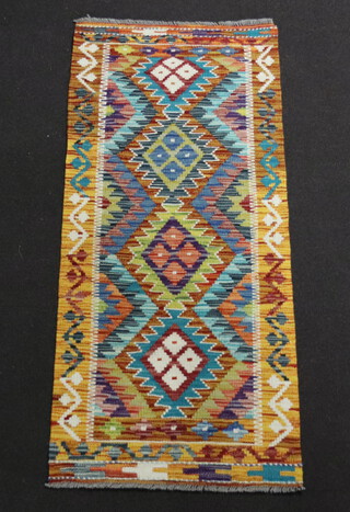 An orange, green and turquoise ground Chobi Kilim runner 150cm x 66cm 