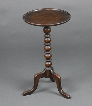 A 1930's circular oak wine table raised on bobbin turned column and tripod base 52cm x 30cm 