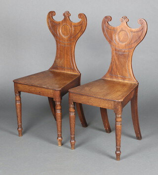 A pair of Georgian mahogany shaped hall chairs with crescent shaped backs, solid seats, raised on turned supports 88cm h x 40cm w x 38cm d 