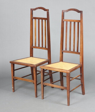 A pair of Edwardian mahogany stick and rail back bedroom chairs with woven rush seats, on square tapered supports 110cm h x 42cm w x 40cm d  