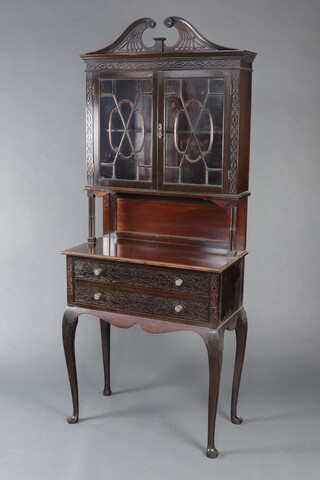 An Edwardian Chippendale style carved mahogany bookcase on cabinet with carved and pierced cornice , the cabinet  fitted a shelf enclosed by an astragal glazed panelled door above a recess, the base fitted 2 long drawers with blind fret work decoration, raised on cabriole supports 190cm h x 76cm w x 39cm d 