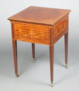 Maple & Company Ltd, an Edwardian square inlaid mahogany surprise drinks table with hinged lid, the interior fitted a twin handled tray, raised on square tapered supports, brass caps and casters 78cm h x 56cm w x 59cm d