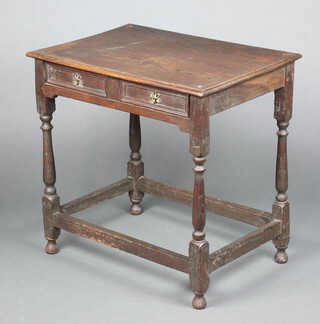 An 18th Century oak side table with geometric moulding, fitted a frieze drawer and raised on turned supports 74cm h x 76cm w x 53cm d 
