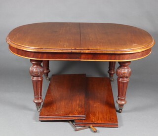 A Victorian oval mahogany extending dining table, raised on turned and fluted supports together with 2 extra leaves and complete with winder 74cm h x 150cm w x 123cm l x 236cm l when fully extended 