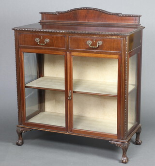 A Chippendale style mahogany display cabinet with raised arched back, fitted 2 long drawers above cupboard enclosed by glazed panelled doors, raised on cabriole supports 125cm h x 107cm w x 50cm d 