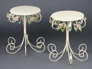 A pair of 1950's circular pressed and wrought metal occasional tables, raised on outswept supports with rose decoration 56cm h x 39cm 