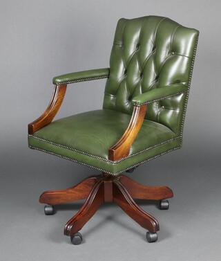 A beech framed revolving office armchair upholstered in green leather finished buttoned material 93cm h x 56cm w x 52cm d (seat 27cm x 30cm)