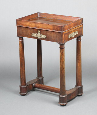 A 19th Century French rectangular mahogany work/dressing table with gilt metal mounts throughout, the hinged tray top fitted a mirror and with leather writing surface, having a drawer to the side with hinged compartment revealing a candlestick, raised on turned columns with H framed stretcher 72cm h x 49cm w x 34cm d 