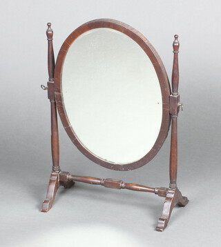 A 19th Century oval plate dressing table mirror contained in a mahogany swing frame 58cm h x 42cm w x 21cm d 