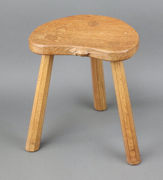 Robert "Mouseman" Thompson of Kilburn, a crescent shaped 3 legged oak stool with adzed decoration and  carved mouse to the side of the seat, raised on chamfered supports 35cm h x 29cm w x 24cm d 