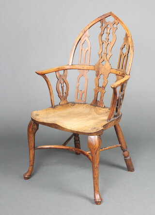 An 18th Century elm and yew Gothic Windsor elbow chair with solid elm seat, raised on cabriole supports with crinoline stretcher, possibly Thames Valley, circa 1760, 107cm h x 55cm w x 45cm d (seat 33cm x 32cm)