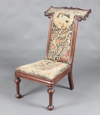 A Victorian carved mahogany show frame prie dieu chair upholstered in tapestry material, raised on  turned supports 95cm h x 48cm w x 51cm d (seat 24cm x 34cm) 