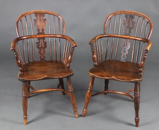 A pair of 19th Century Nottinghamshire yew and elm low back, vase slat back Windsor chairs with solid elm seats, raised on turned supports with 3 ring turnings to the front and crinoline stretcher, circa 1840 one chair 88cm high the other 89cm high x 48cm x 40cm (seats 30cm x 31cm) 
