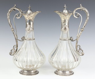 A pair of German white metal mounted ewers with acanthus handles, stamped Foehr 13, 28cm h 