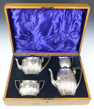 A silver 4 piece demi-fluted tea and coffee set with ebony mounts, Sheffield 1920, 1705 grams gross, contained in a fitted oak box 