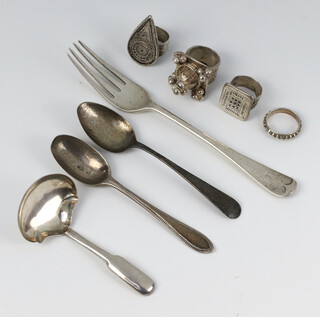 A Georgian silver caddy spoon, 2 teaspoons, a fork and 4 white metal rings 122 grams 