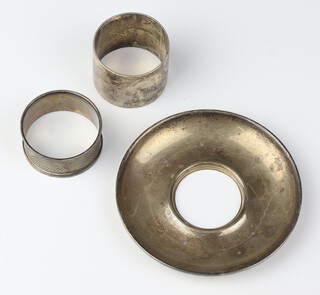 A silver napkin ring Sheffield 1904, a dish base and 1 other napkin ring, 113 grams