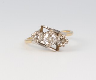 A yellow metal 18ct 3 stone diamond crossover ring, approximately 0.45ct, 2.8 grams, size I 
