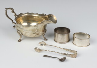 A silver sauce boat with S scroll handle  Birmingham 1912, 2 napkin rings, spoon and pair of sugar nips 242 grams 