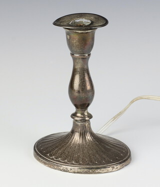 A Georgian silver candlestick of waisted form converted to electricity, rubbed marks, 17cm 