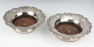 A pair of 19th Century silver plated champagne coasters with vinous decoration 21cm 