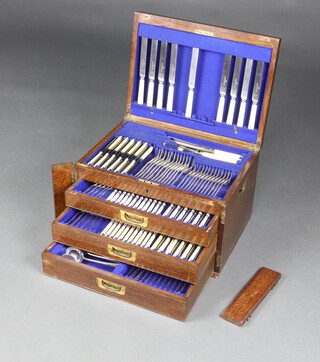 An Edwardian oak canteen containing a matched set of silver plated cutlery, 1 side locking bar is detached  