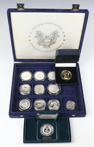 Nine silver commemorative American dollars, 2 silver commemorative crowns and a silver half dollar, 310 grams 