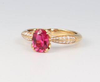 Kat Florence, an 18ct yellow gold oval cut red tourmaline ring approx. 1.13ct, the shoulders with brilliant cut D flawless diamonds 0.35ct, size P, 4 grams, with original paperwork stating flawless diamonds and original box 