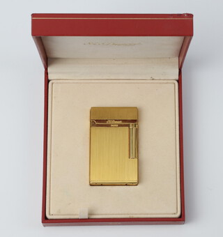 A gentleman's gold plated Dupont cigarette lighter with leather pocket in original box Numbered IC 5 J E 7 8