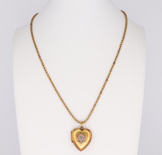 A yellow metal necklace 56cm, 9.6 grams and a yellow metal 15ct heart shaped diamond set locket, the diamond 0.25ct 