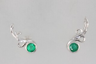 A pair of white metal emerald and diamond floral ear studs, the emeralds each approx. 0.15ct, 2 grams 
