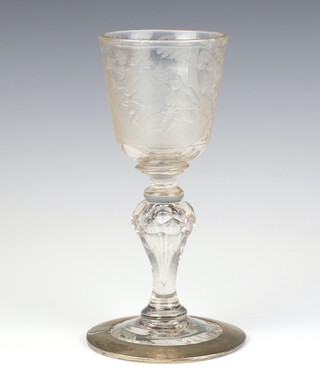 An 18th Century glass goblet engraved with a scene of lady and gentleman with an angel before a country house, with faceted panel on a waisted stem, now with a white metal base 22cm 