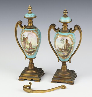 A pair of 19th Century French porcelain gilt metal mounted vases and covers decorated with lakeside scenes and figures 25cm 