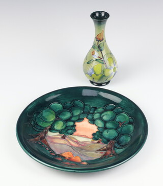 A modern Moorcroft green ground plate with landscape view 26cm, a ditto oviform vase decorated with flowers 16cm 